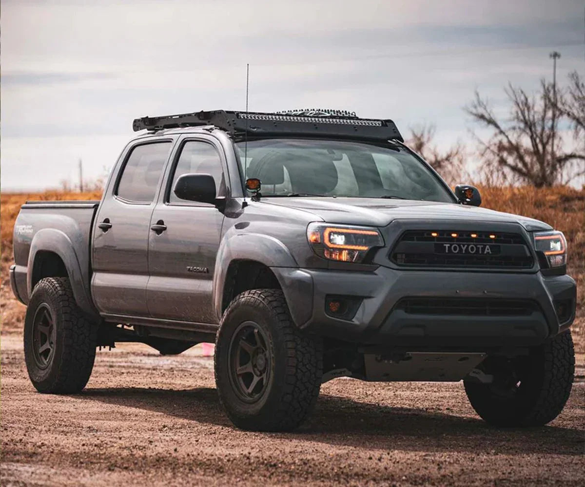 Toyota Tacoma with Prinsu roof rack and off-road gear parked outdoors