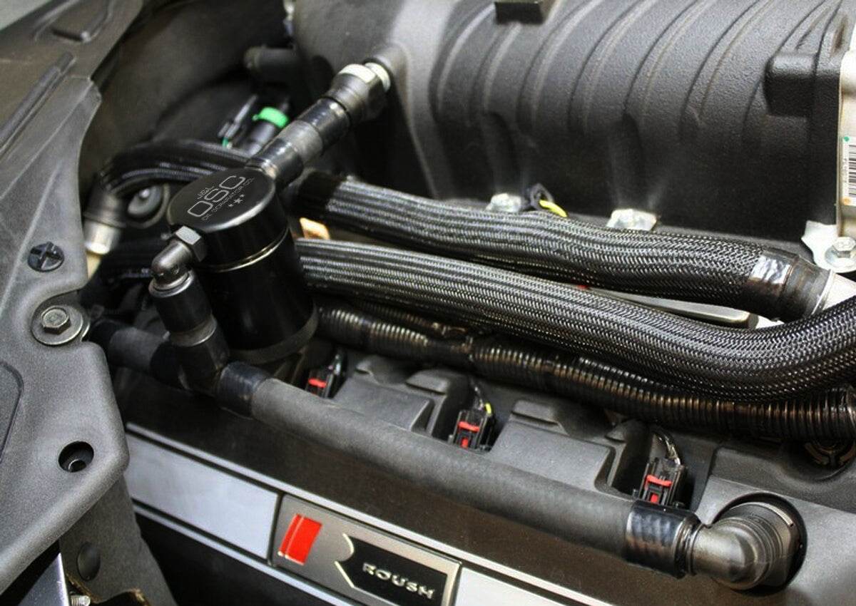 J&L Oil Separator 3.0 Passenger Side, Black Anodized installed in a car- S&B