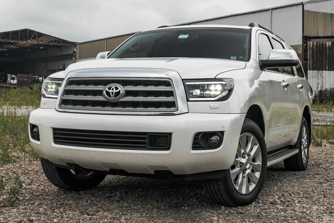 Front view of a white Toyota Tundra with XB LED headlights in an outdoor setting.