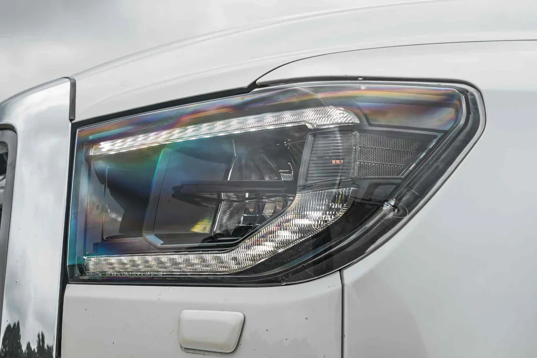Close-up of modern LED headlight on white Toyota Tundra truck