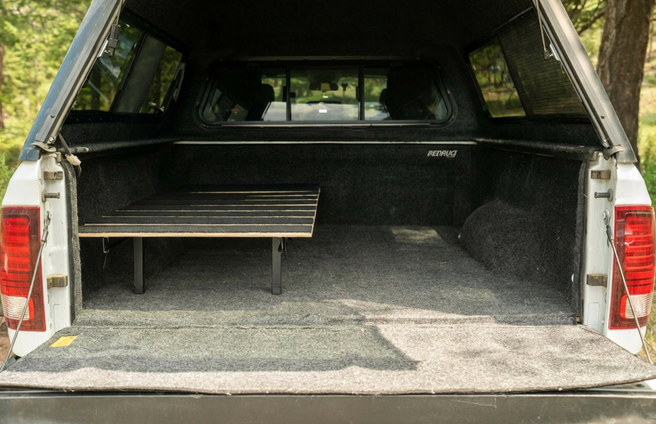 Nokhu Half Rack New Model steel and pine sleep platform installed in SUV cargo area with gear stored underneath