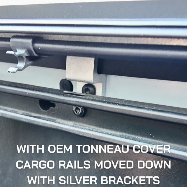 Closeup of OEM tonneau cover cargo rail system with silver metal bracket installed