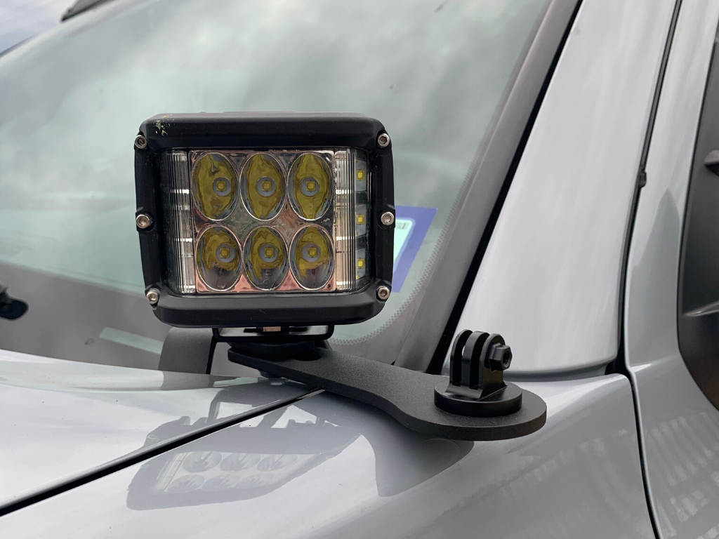 LED pod light mounted on vehicle hood for overlanding and off-road adventure gear