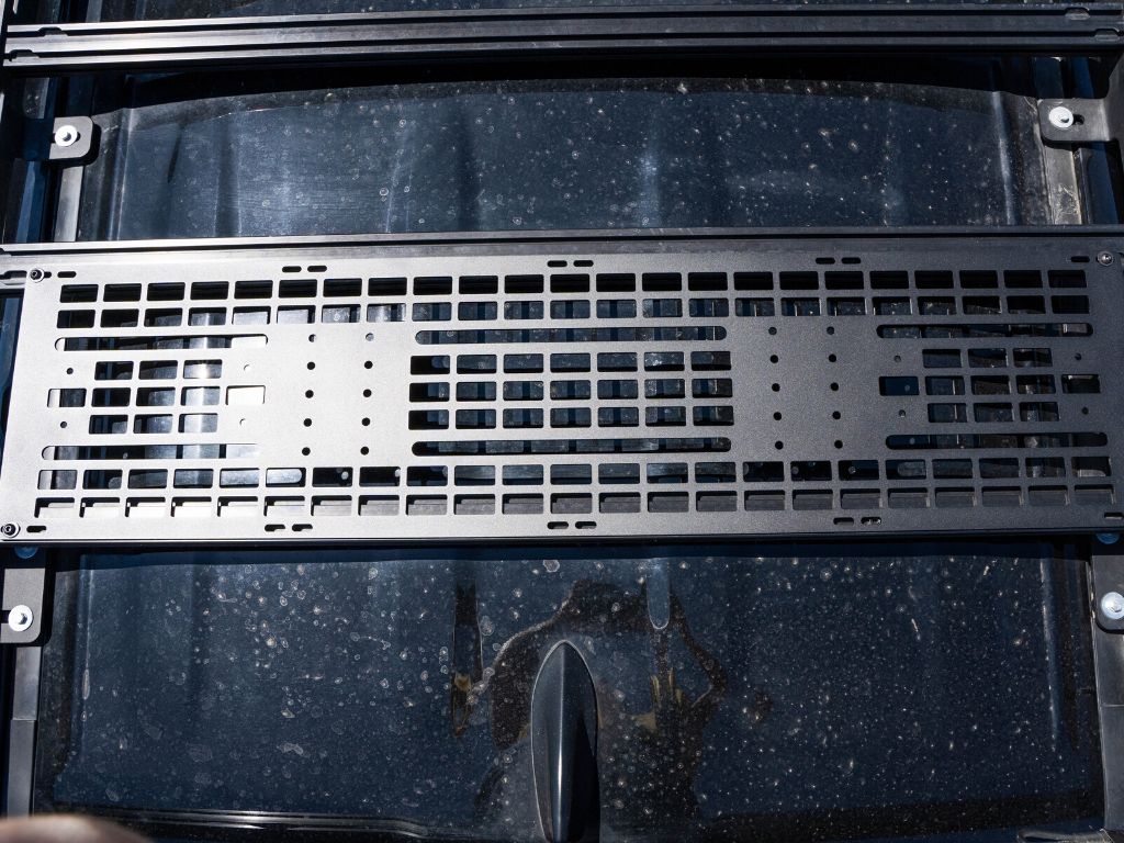 Black modular roof rack accessory panel mounted on a vehicle roof, ideal for overlanding gear