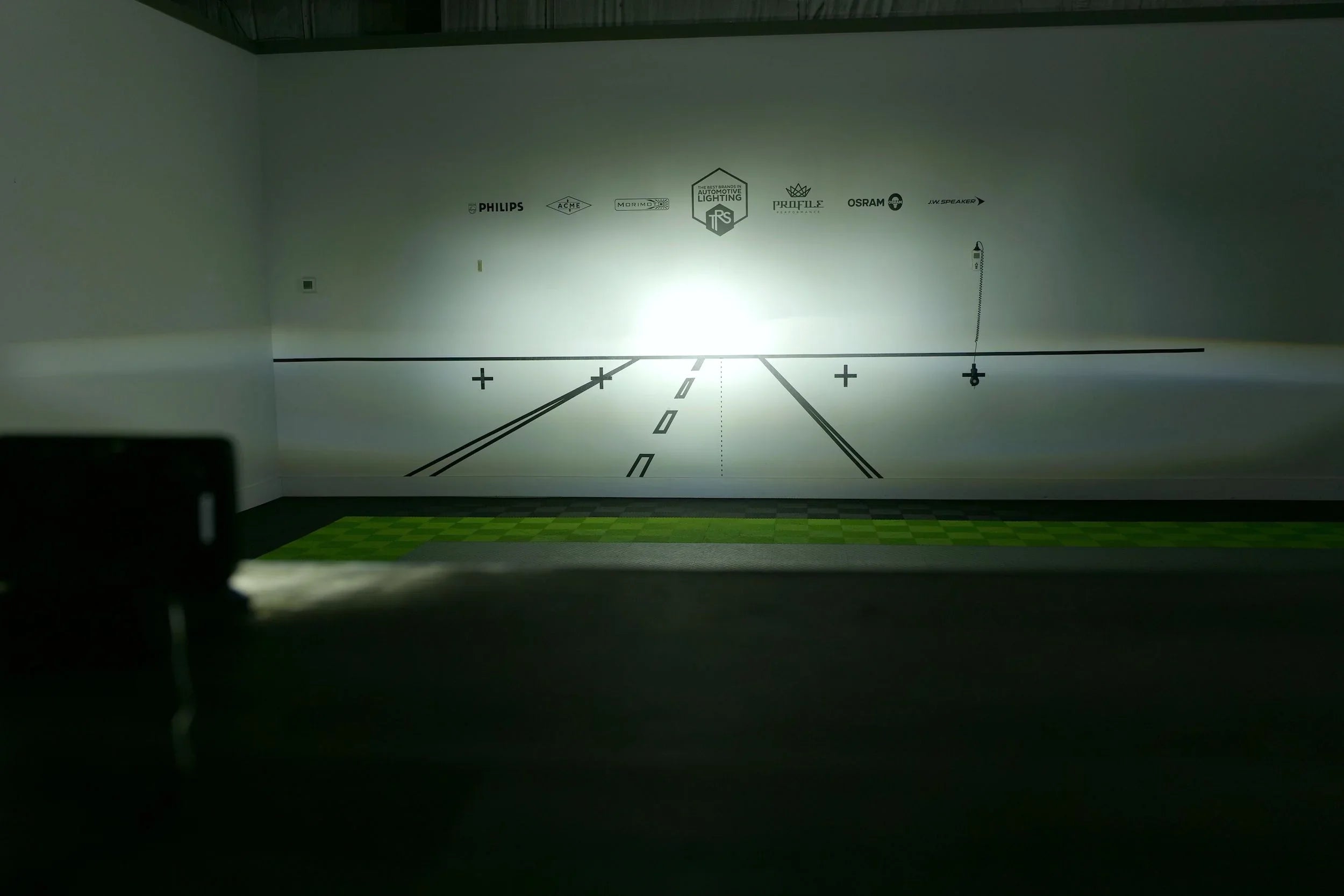 LED headlight beam pattern projected on test wall for automotive lighting comparison