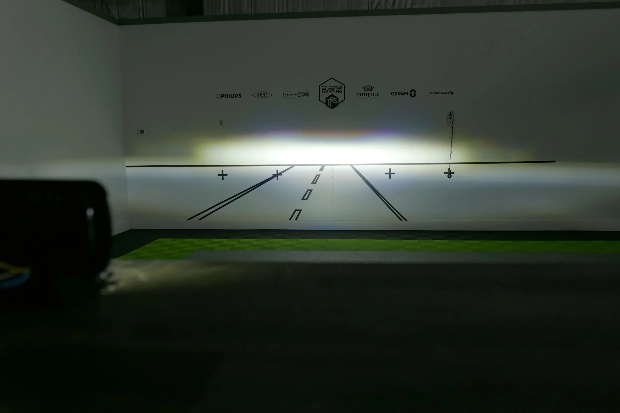 Bi-LED 5x7 headlight beam pattern displayed on a wall in a lighting test setup