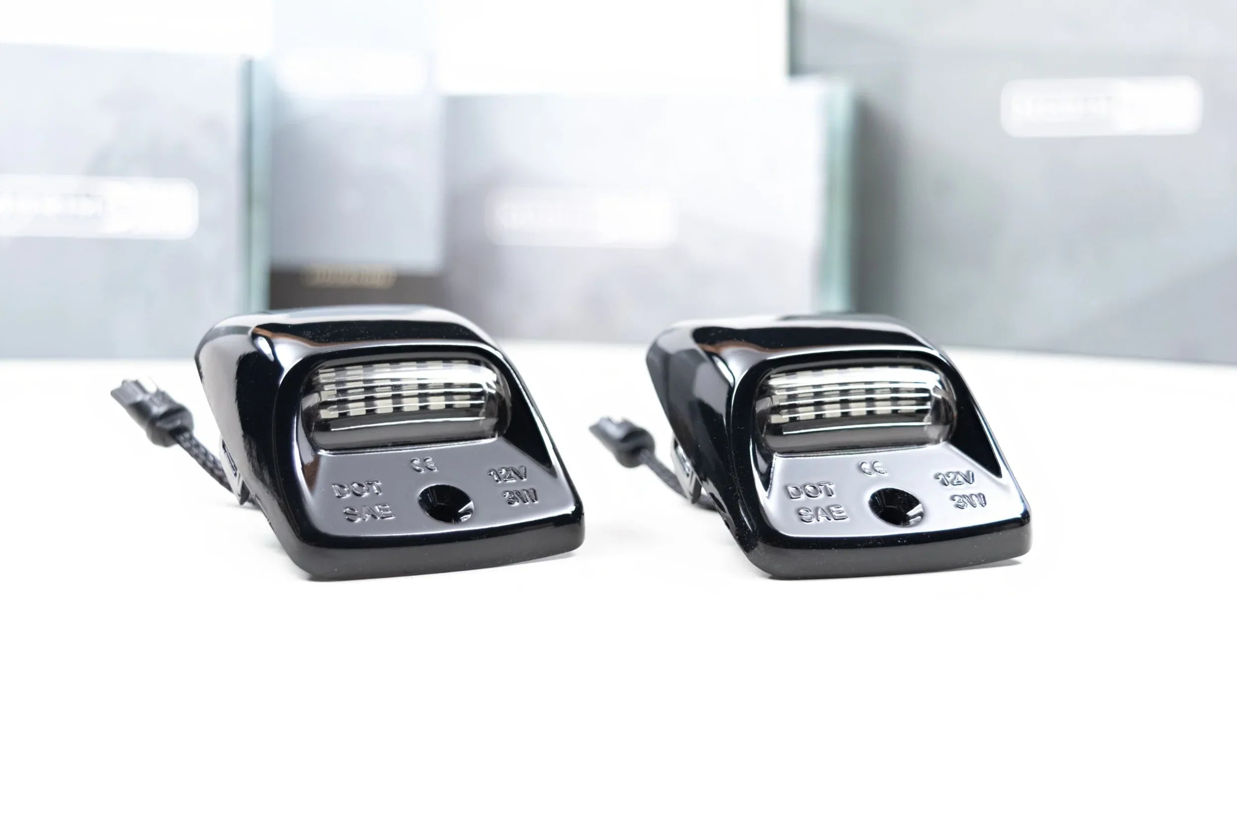 Pair of black LED license plate lights for Toyota Tacoma on white background