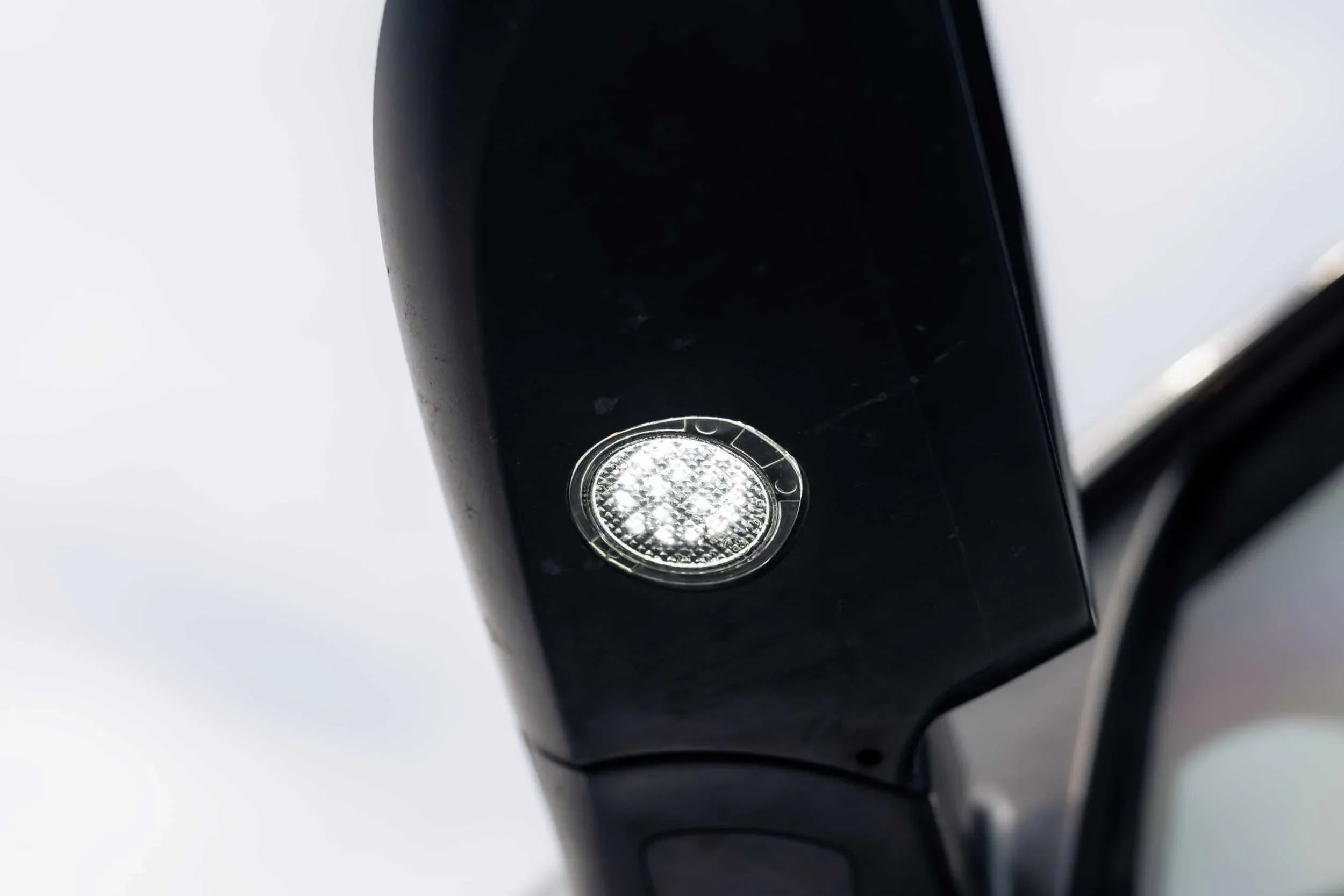 Close-up of LED mirror light installed on Toyota Tundra side mirror for off-road visibility