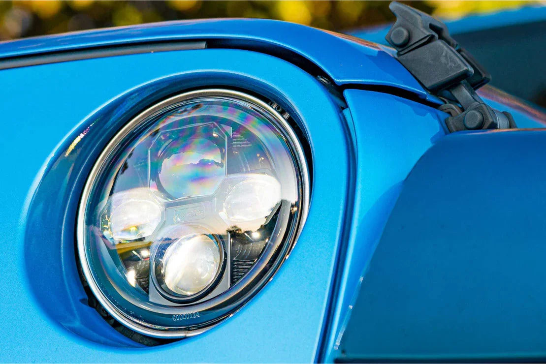 Close-up of LED headlight on blue overland vehicle, ideal for off-road camping upgrades