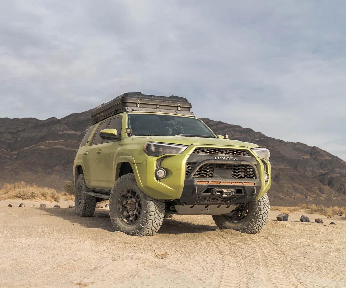 Toyota 4Runner with low profile covert front bumper and roof rack in desert landscape