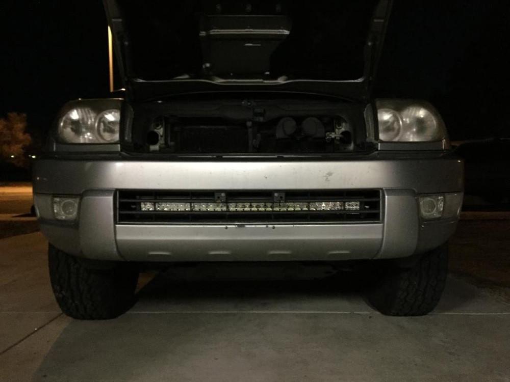 Front view of Toyota 4Runner with hood open, featuring aftermarket LED light bar