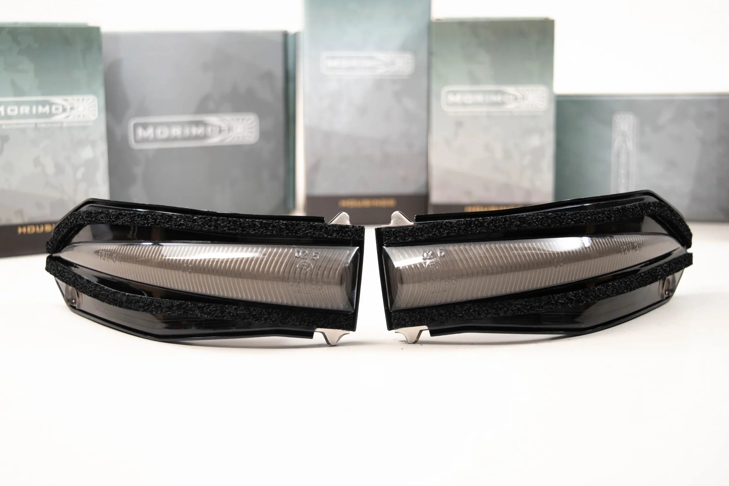 Toyota 4Runner smoked LED side mirror lights with textured trim, product boxes in background
