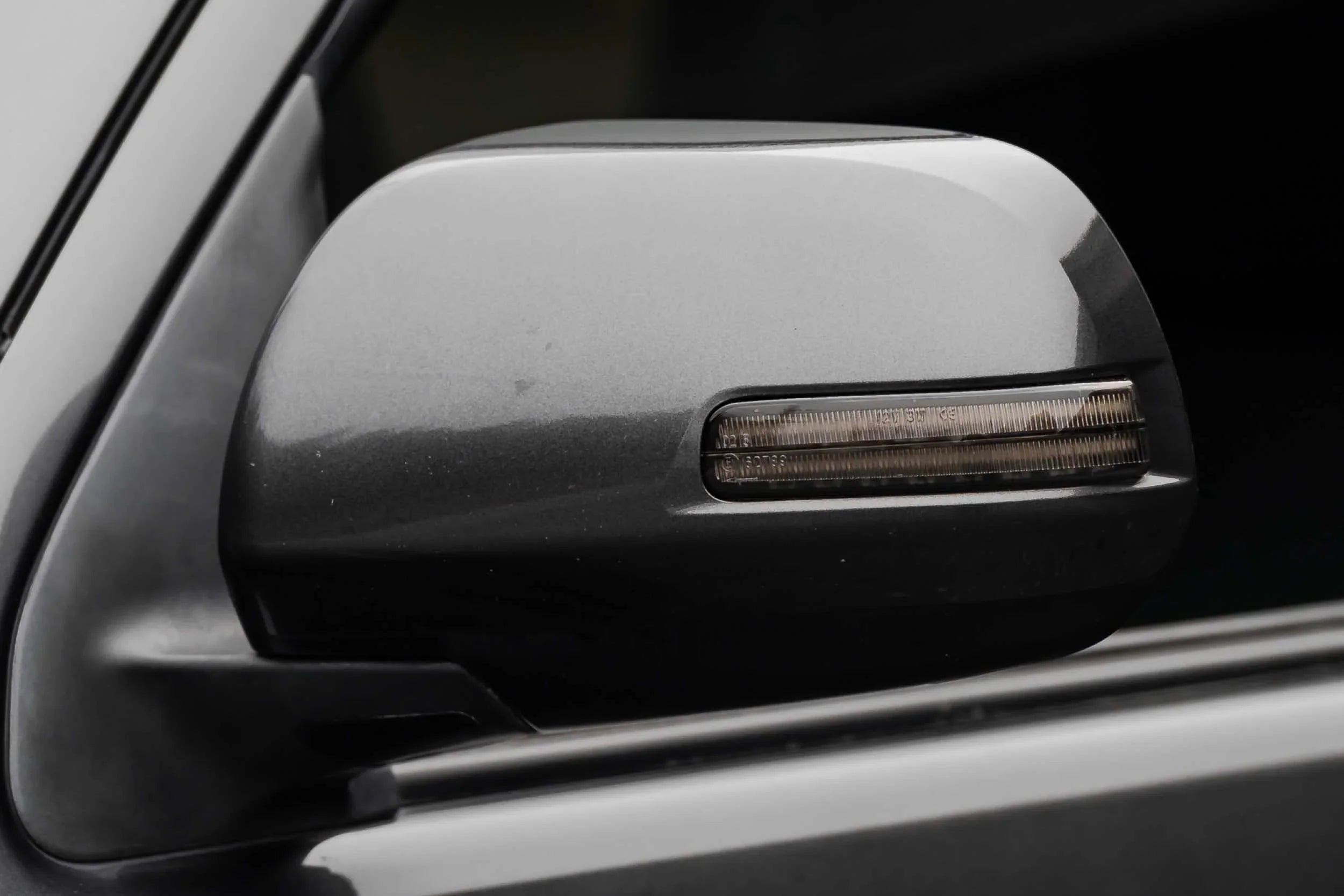 Close-up of Toyota Tacoma side mirror with integrated LED signal light