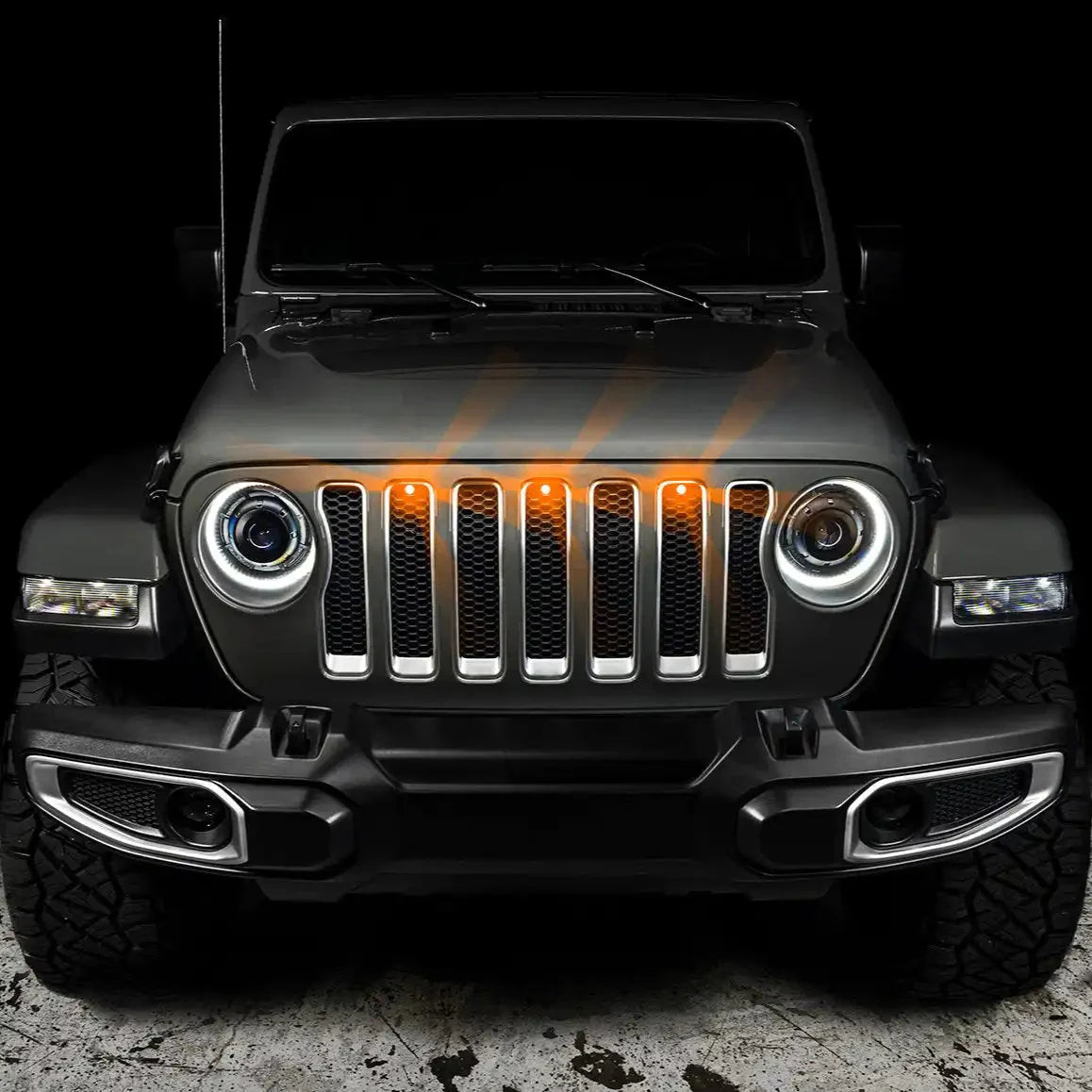 Front view of Jeep Wrangler with LED grille marker lights and halo headlights, off-road style