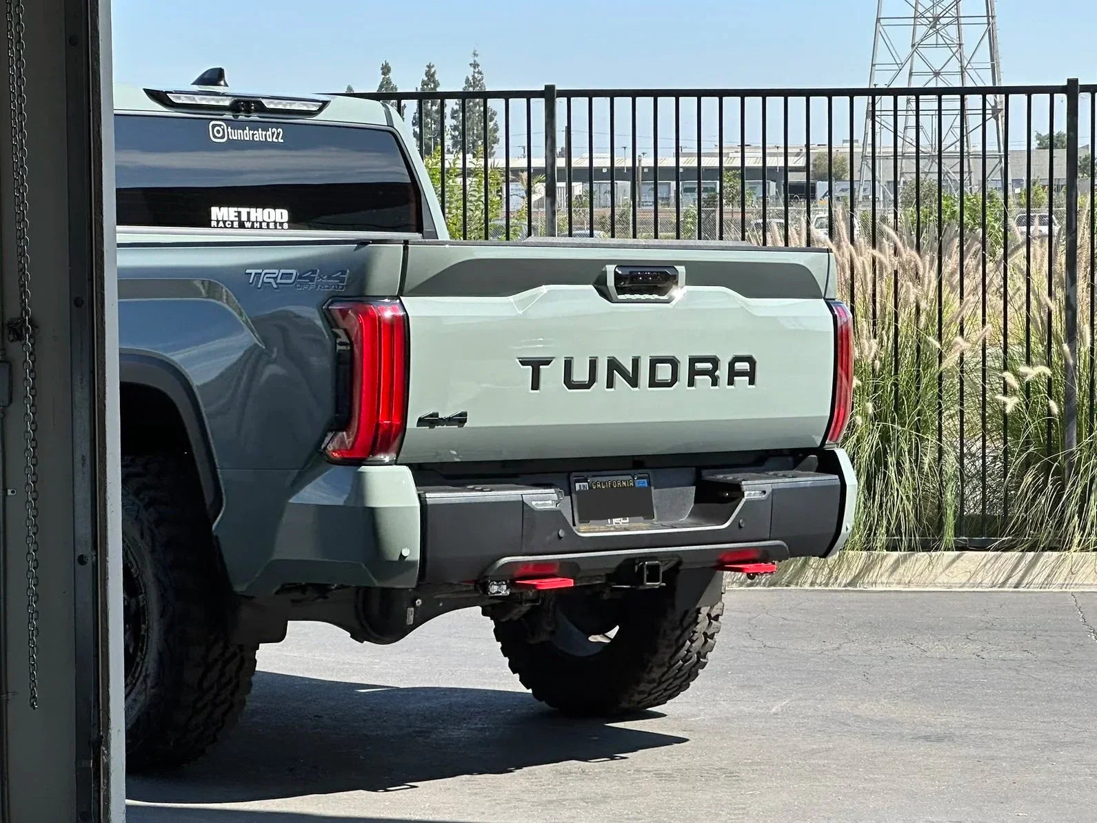 Toyota Tundra TRD 4x4 off-road truck parked outdoors, rear view with tailgate and decals visible