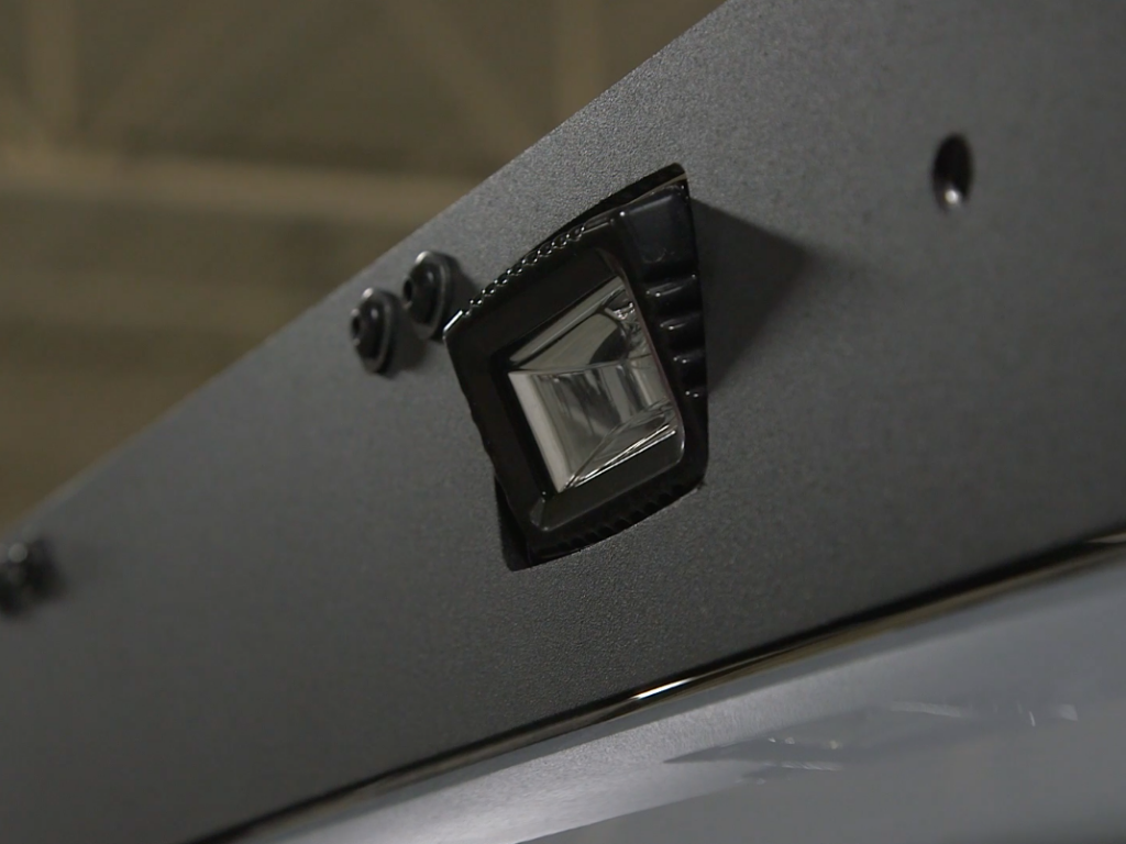 Close-up of mounted LED light on rugged vehicle accessory for overlanding or camping