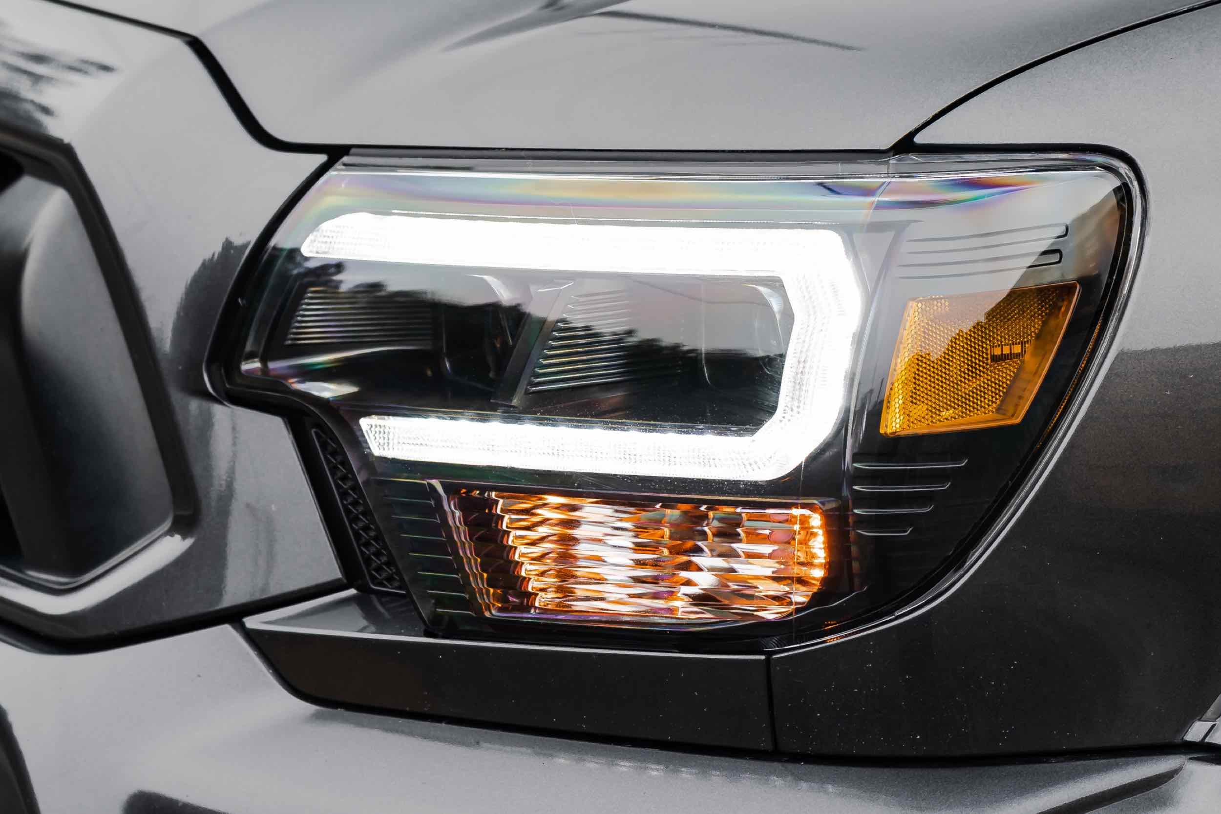 Close-up of Toyota Tacoma XB Hybrid LED headlight on grey truck