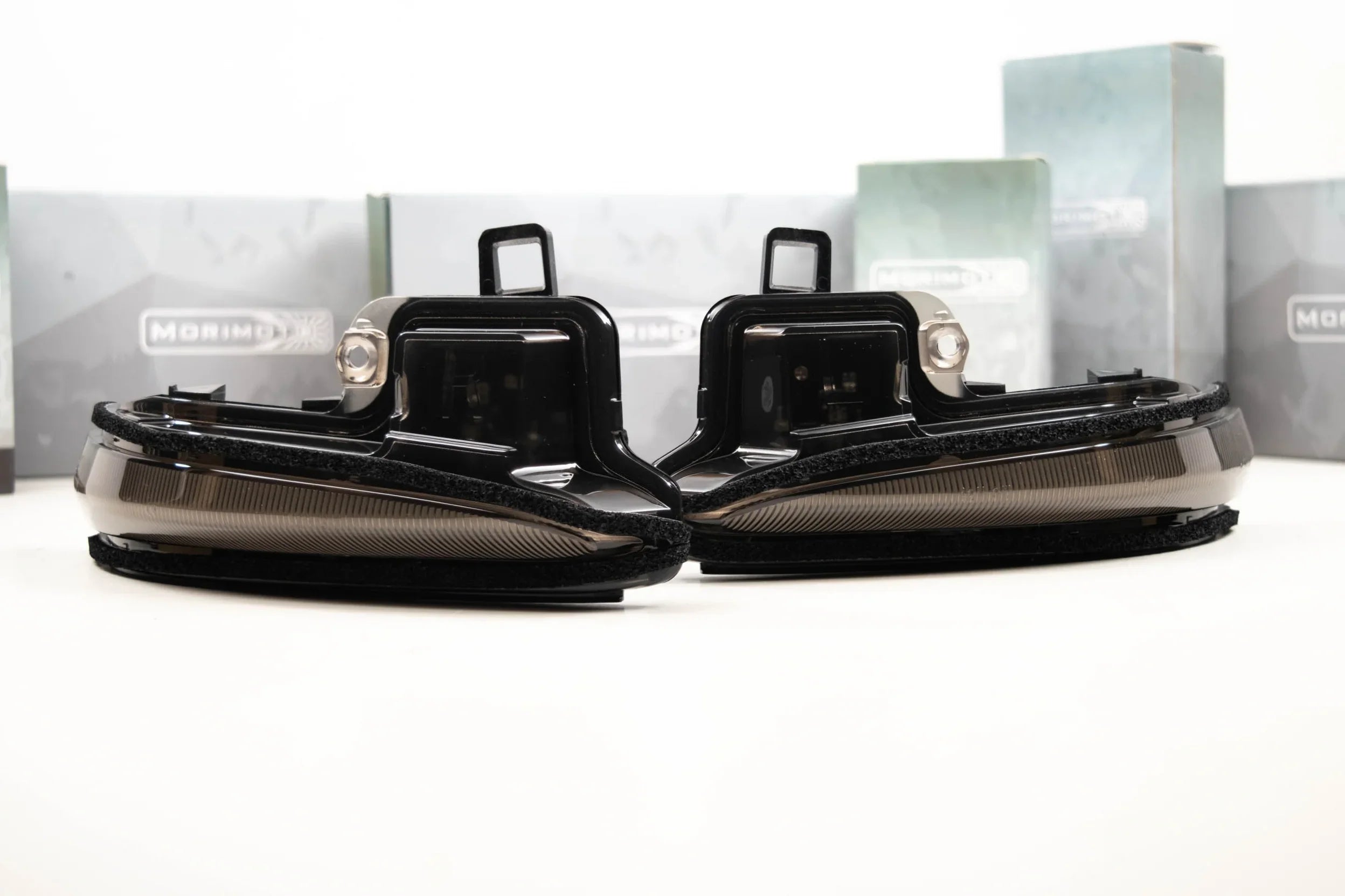 Pair of smoked LED mirror turn signal lights for Toyota Tacoma, displayed on white background.