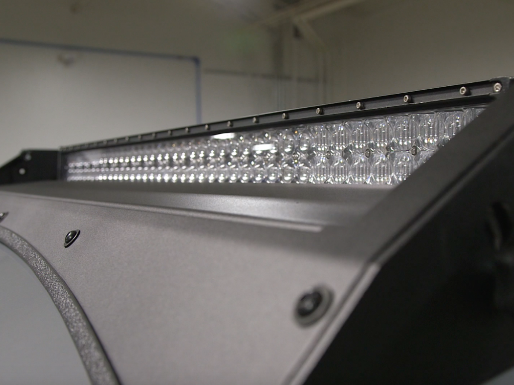 Close-up of LED light bar mounted on overland vehicle roof rack for off-road adventure