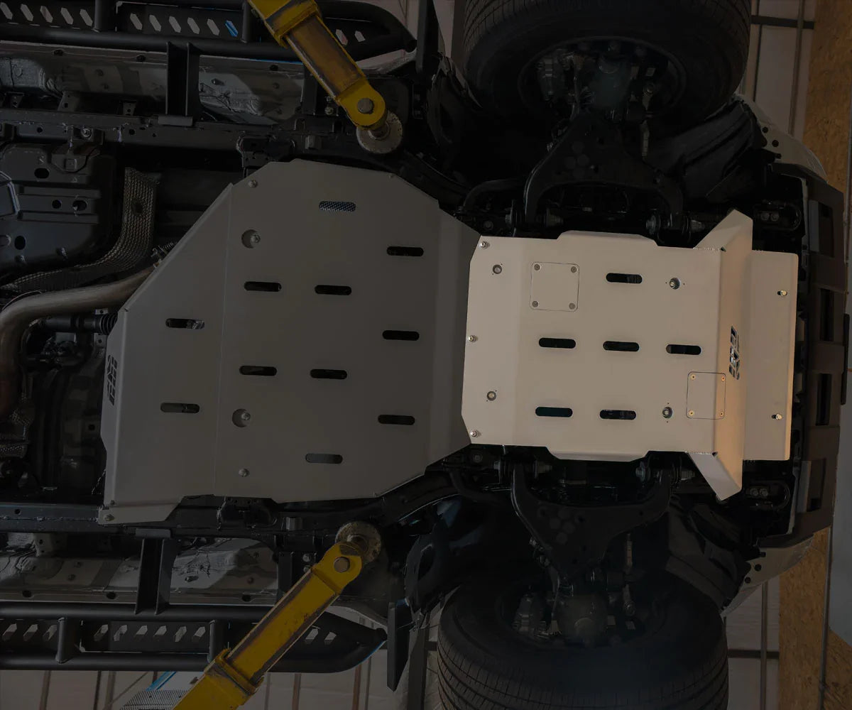 Steel front skid plate installed under a Toyota 4Runner, vehicle undercarriage view