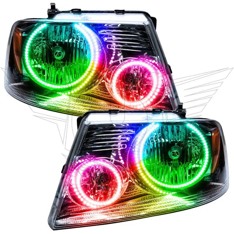 Pair of aftermarket RGB halo headlights for Toyota Tacoma, featuring vibrant multicolor LED rings.