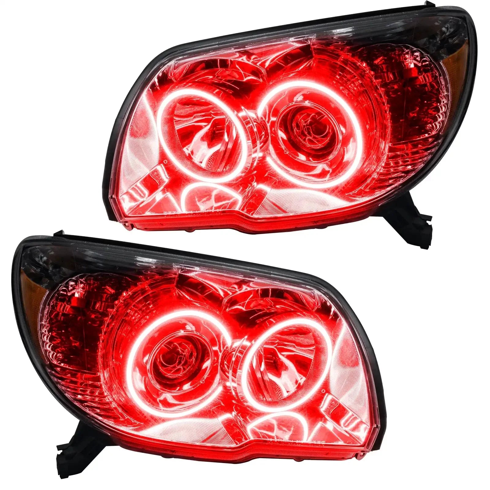 Pair of custom red halo projector headlights for Toyota Tacoma, illuminated and angled