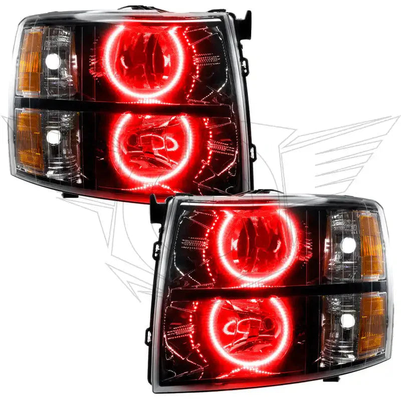 Pair of aftermarket truck headlights with red LED halo rings and clear amber lens accents
