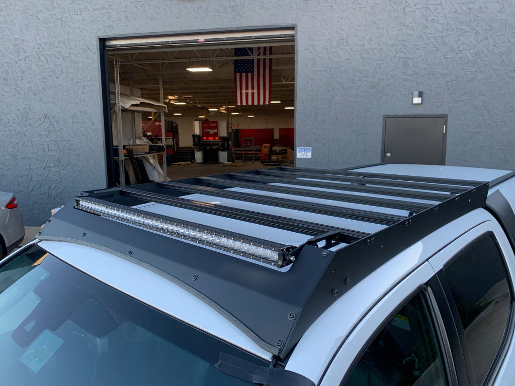 Toyota vehicle with overland roof rack and LED light bar for expedition camping