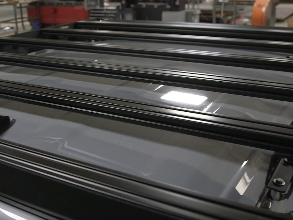 Close-up of black aluminum rooftop cargo rack for off-road vehicle or overlanding SUV.
