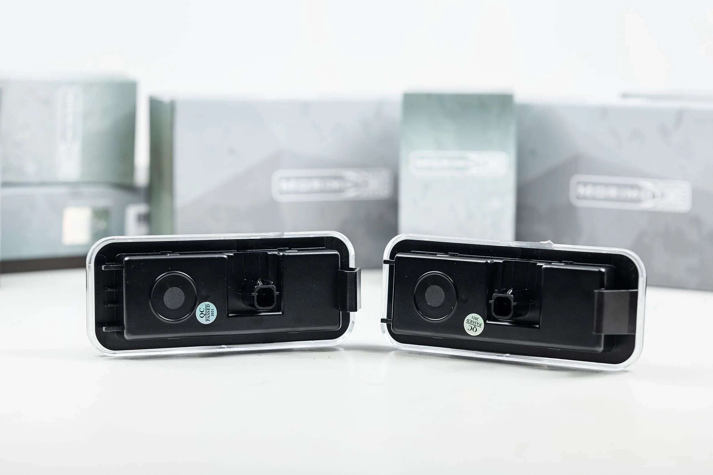 Pair of black LED license plate lights for Toyota Tacoma, shown on white background