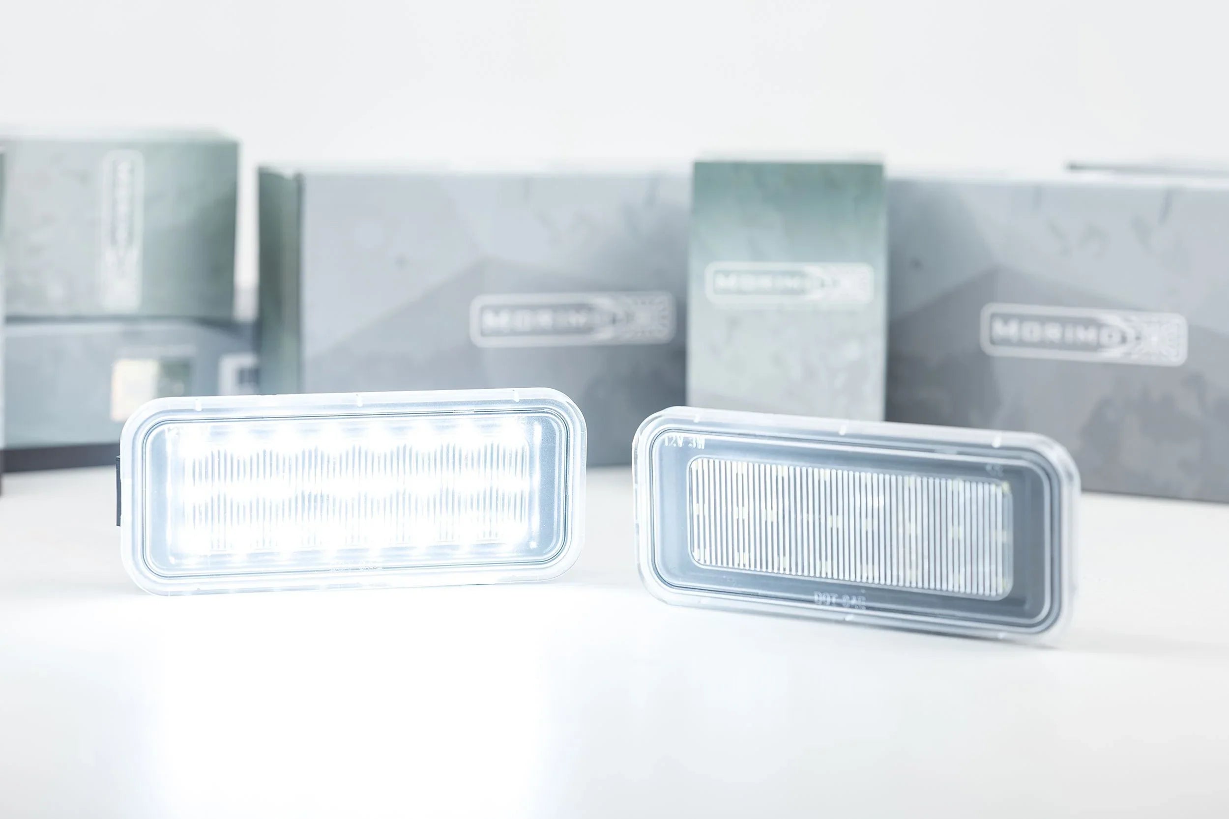 Rectangular LED vehicle lights for off-road or overlanding, displayed with packaging.