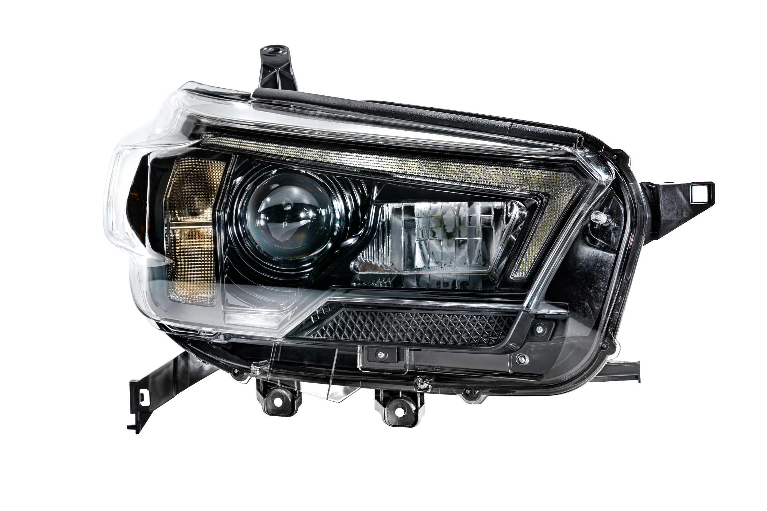 LED projector headlight assembly for Toyota Tacoma on white background