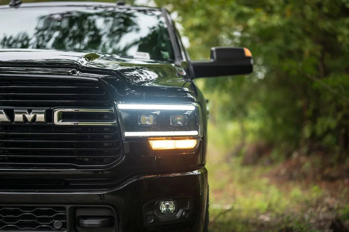 Close-up of black off-road truck grille and headlights on forest trail