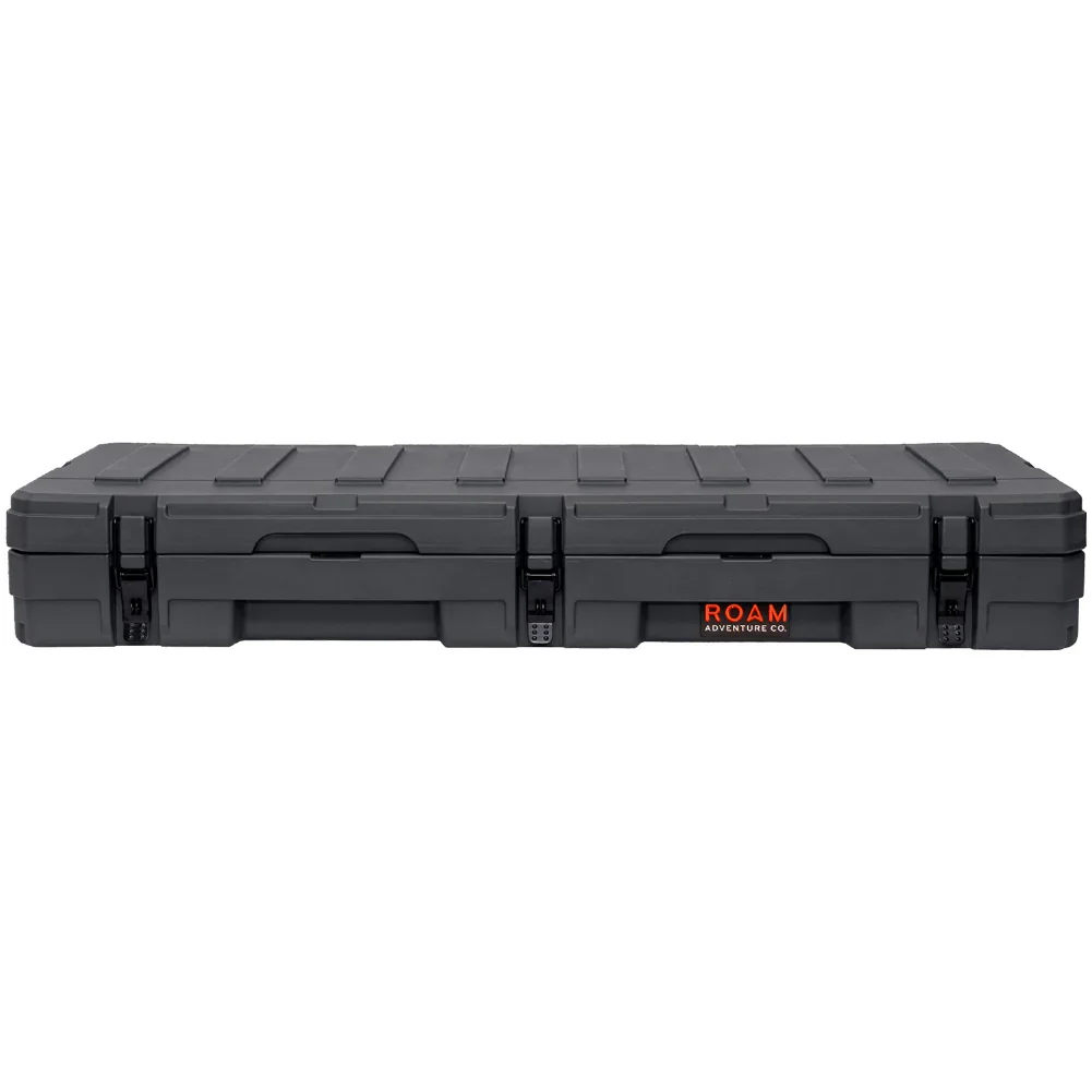 Black hard-shell rooftop cargo storage box with locking latches for overlanding vehicles