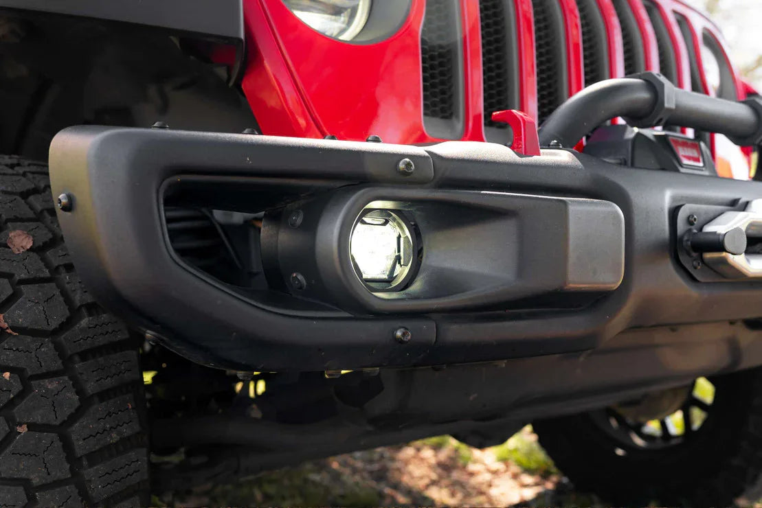 Close-up of a Jeep Wrangler front bumper with off-road fog light and winch
