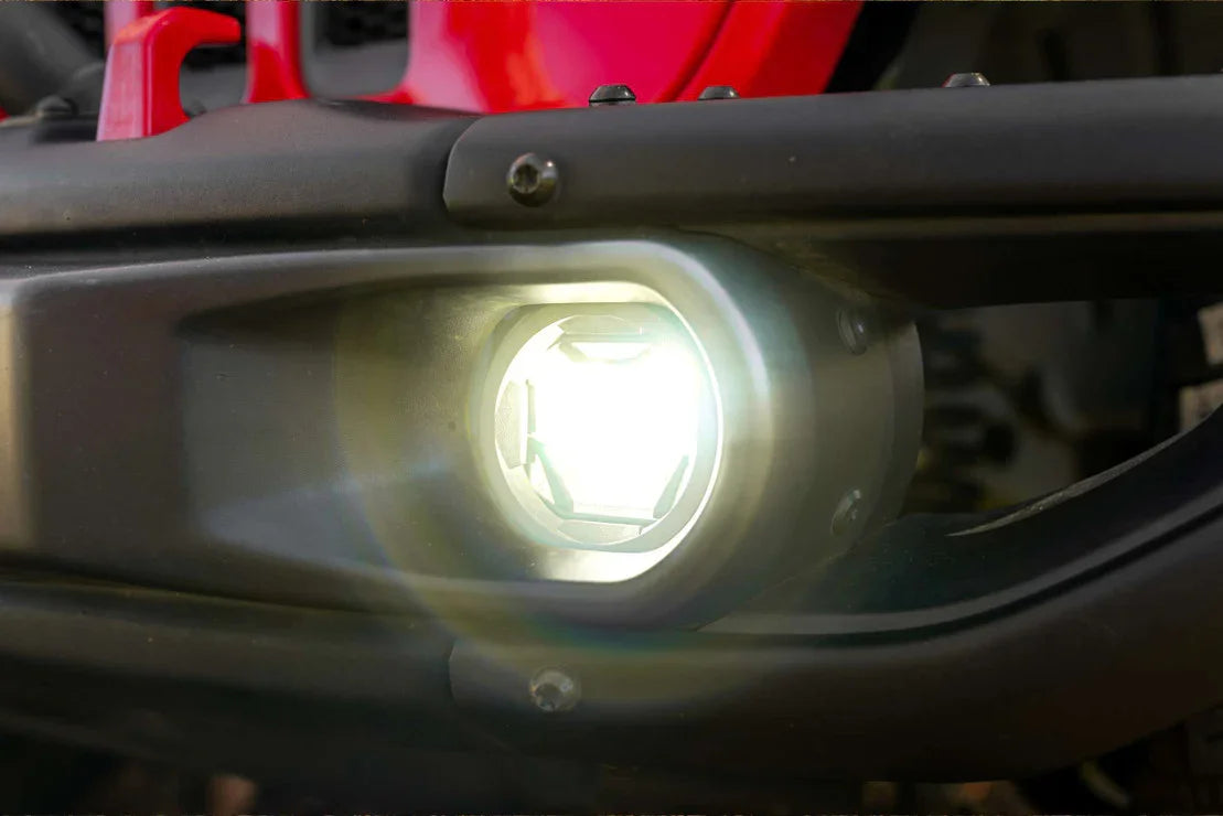 Close-up of off-road LED fog light on front bumper of red adventure vehicle