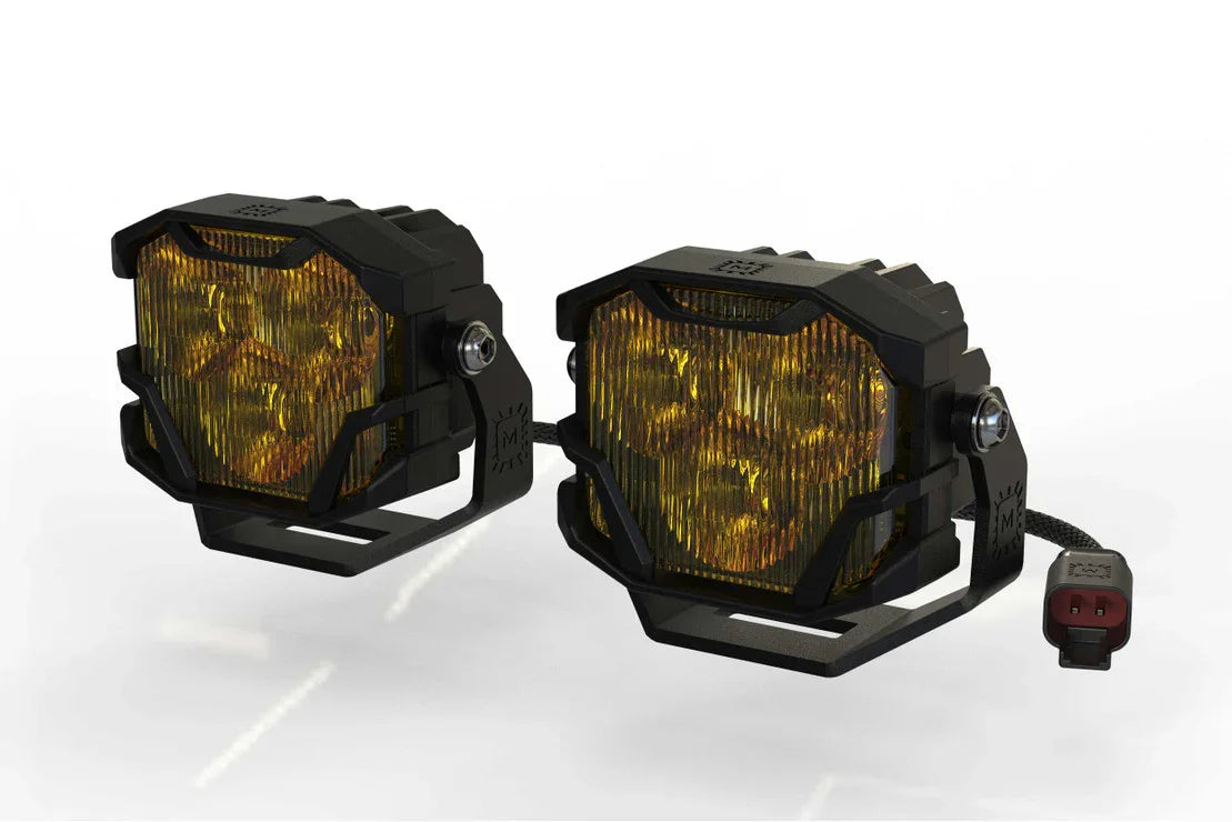 Pair of yellow LED off-road pod lights with black protective housings for overlanding vehicles