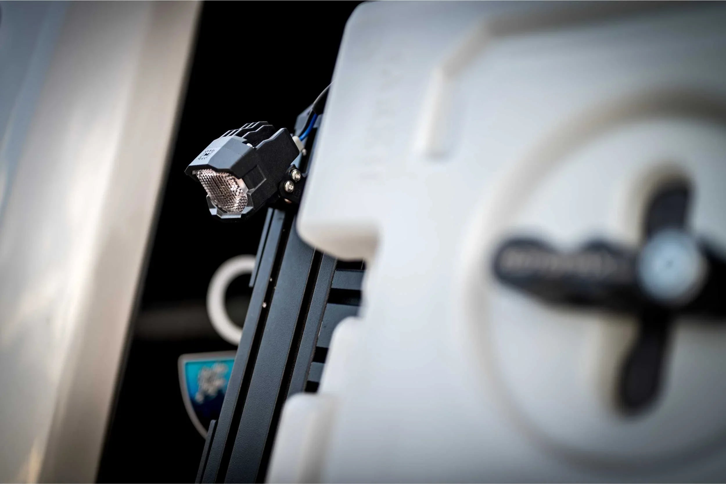 Close-up of off-road vehicle accessory mount with LED light and water storage container