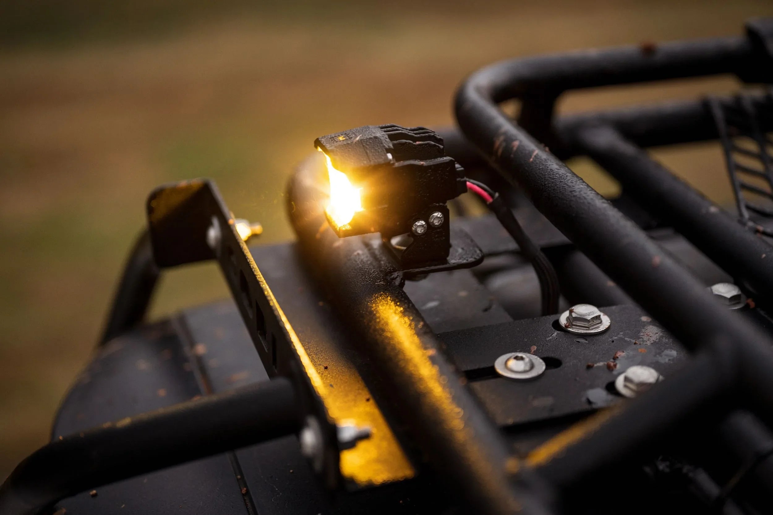 Close-up of LED off-road roof rack light mounted on a vehicle, illuminated outdoors