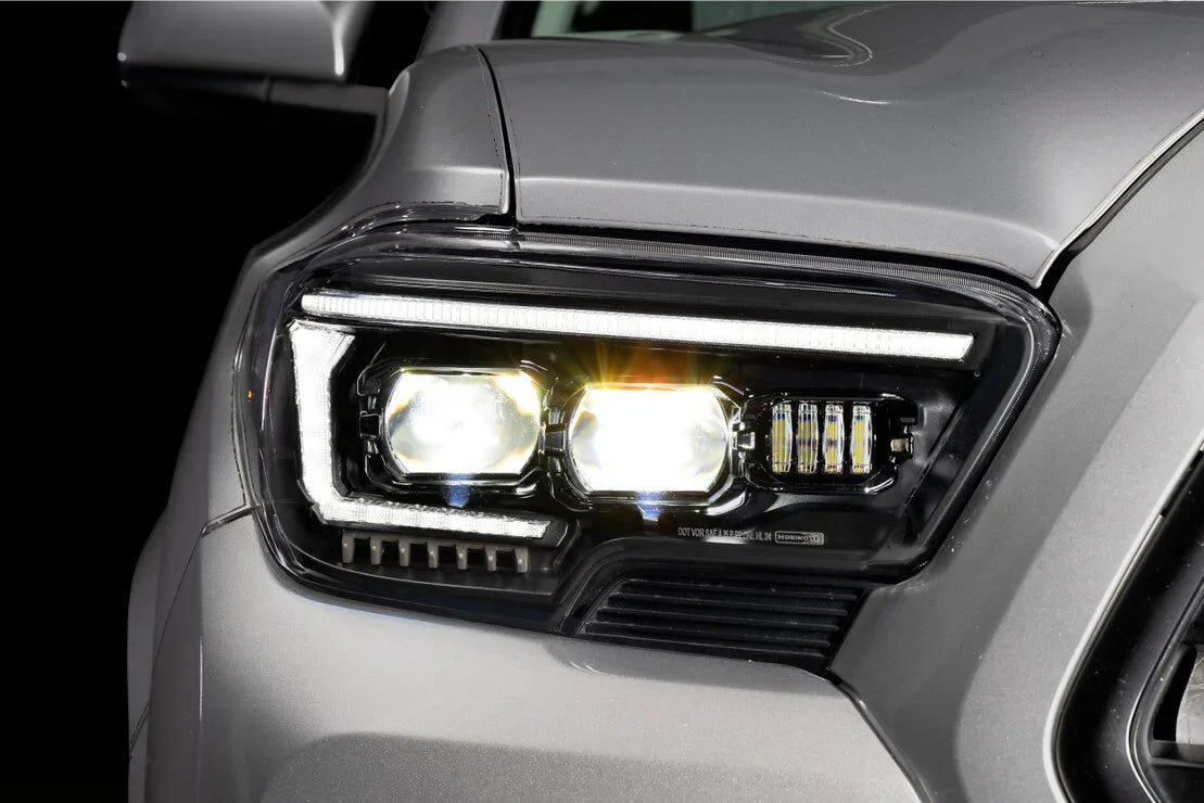 Close-up of LED headlights on a gray Toyota Tacoma, bright and modern lighting detail