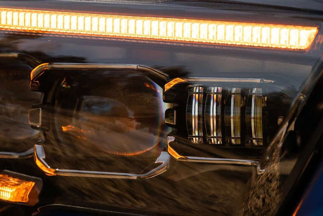 Close-up of Toyota Tacoma XB Evo LED headlight with amber DRL for off-road vehicle