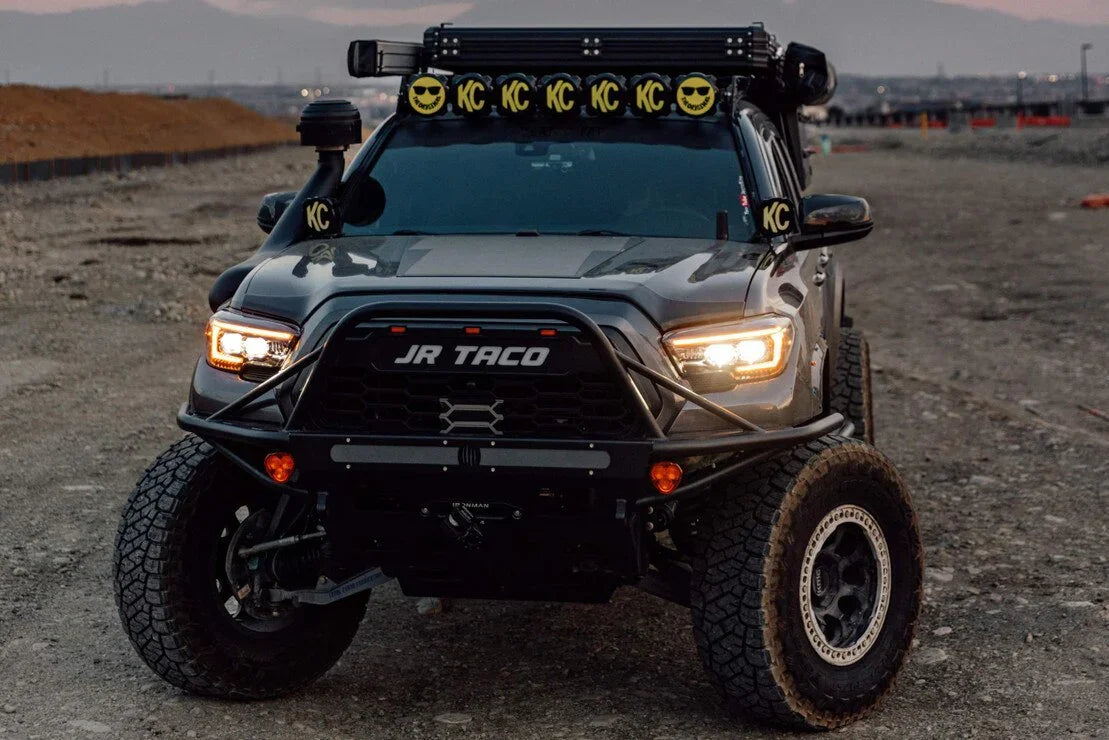 Front view of a modified Toyota Tacoma with off-road headlights and rugged accessories