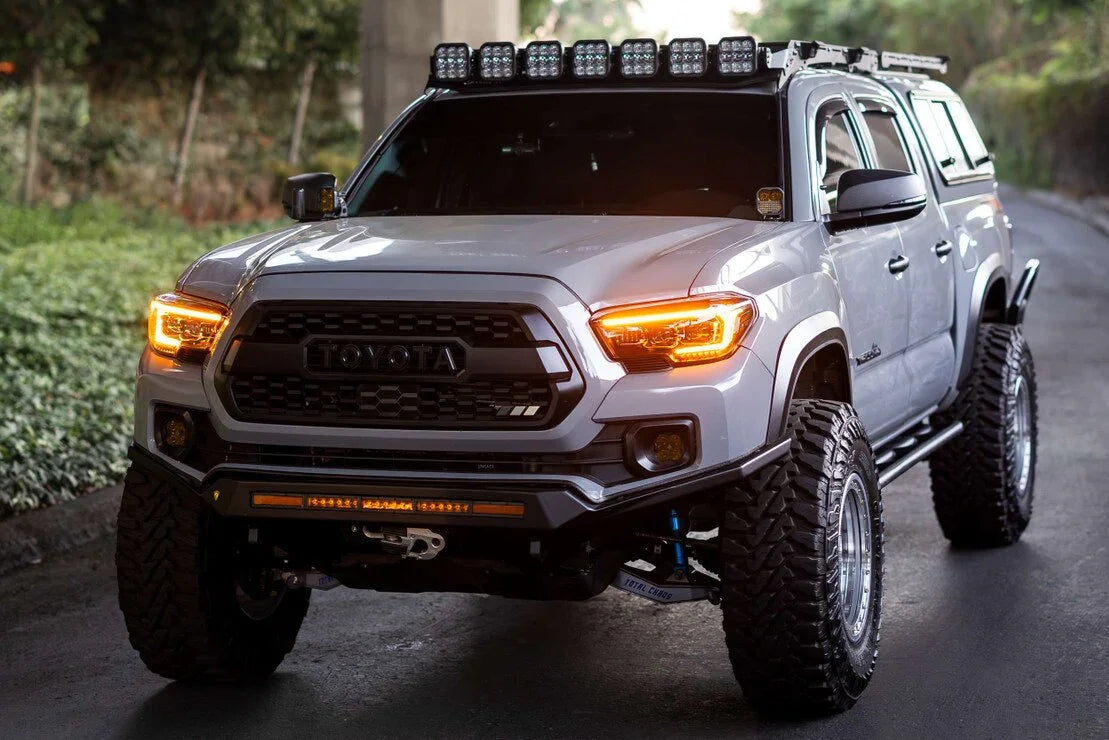 Toyota Tacoma with upgraded XB Evo headlights, off-road tires, and roof rack lights