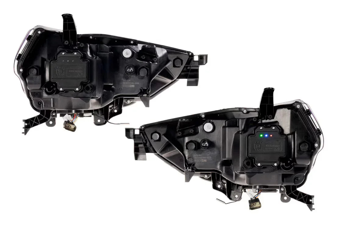 Pair of black aftermarket vehicle headlight housings with wiring connectors