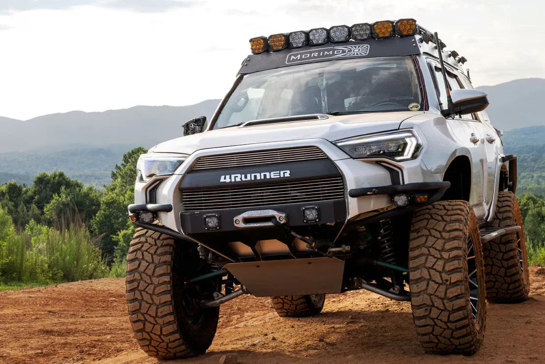 Lifted Toyota 4Runner with off-road tires, roof lights, and expedition gear parked outdoors