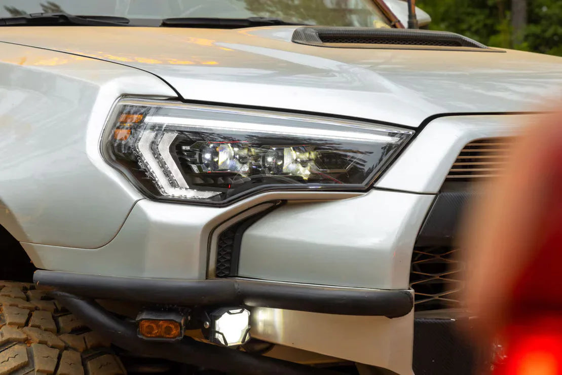 Close-up of off-road vehicle LED headlight and rugged bumper with auxiliary lights