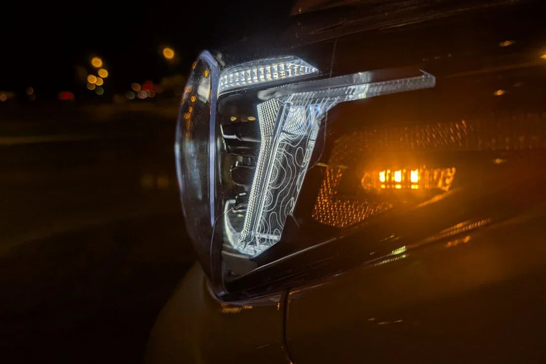 Close-up of illuminated Toyota Tacoma XB Evo Hybrid LED headlight at night