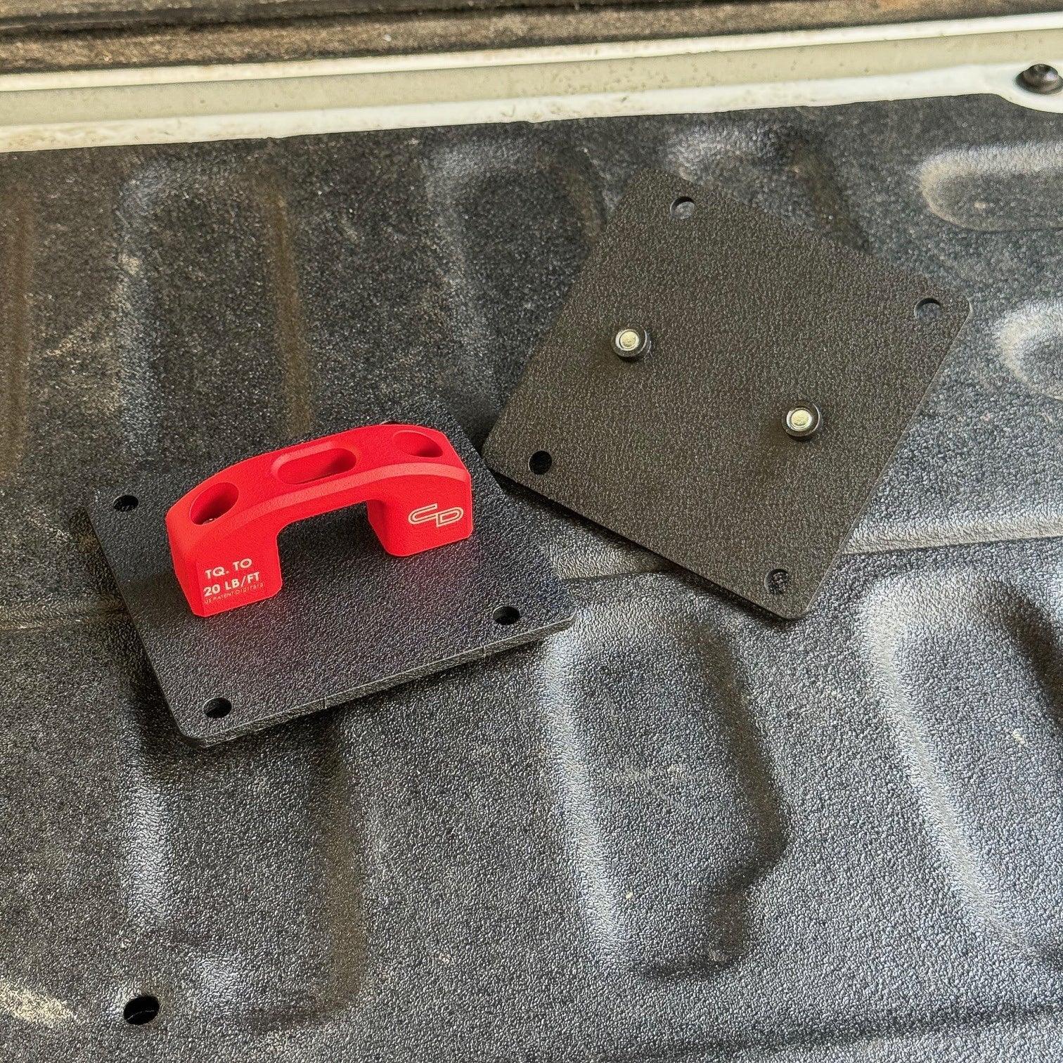Replacement mounting plate with red tie-down anchor for truck bed or vehicle gear storage