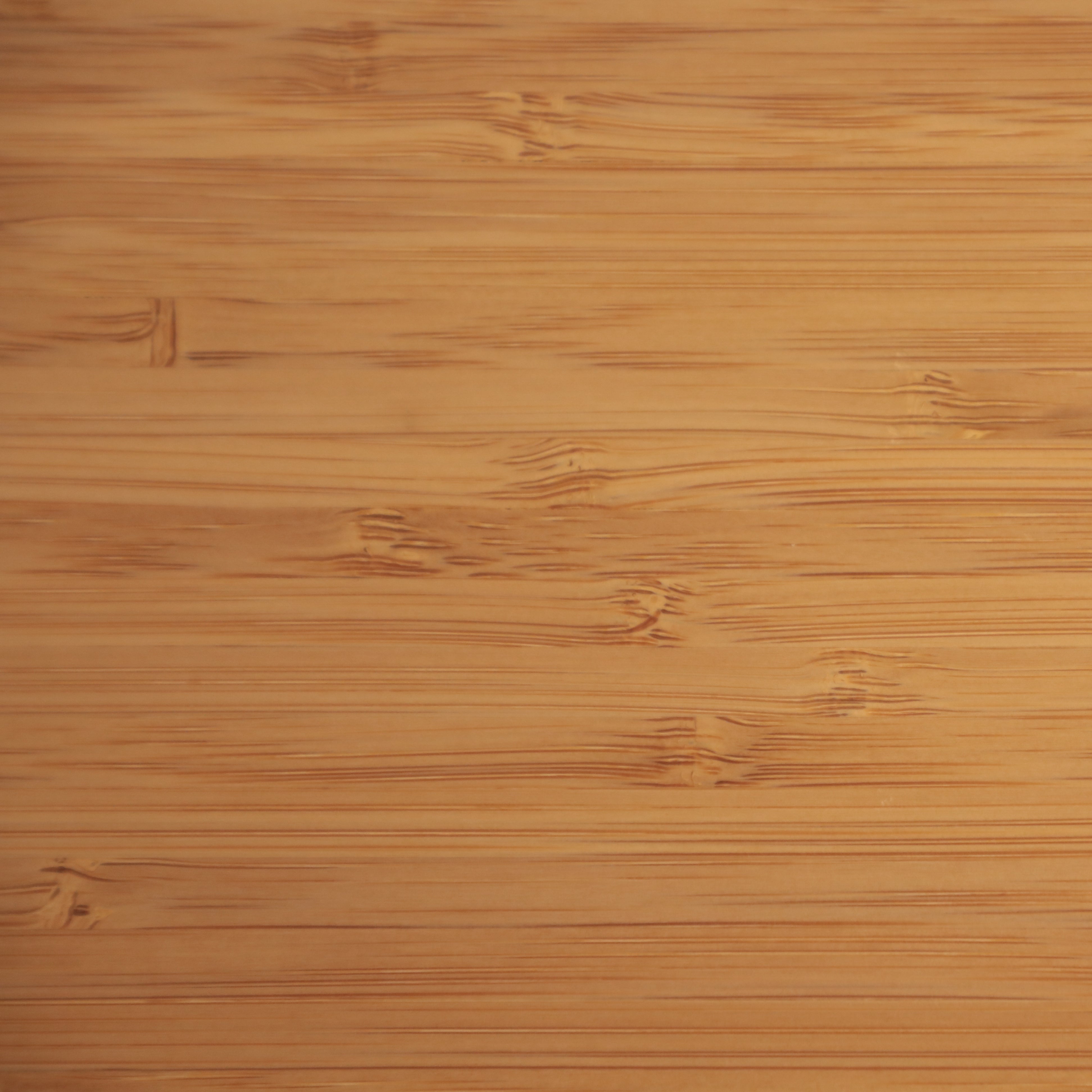 Close-up of smooth bamboo wood texture with natural grain and light brown color