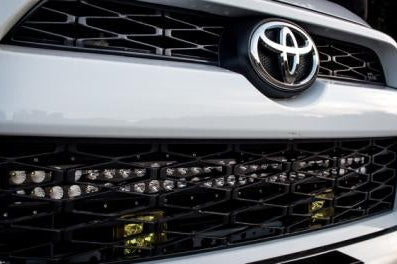 Toyota truck front grille with LED light bar and off-road lighting accessories